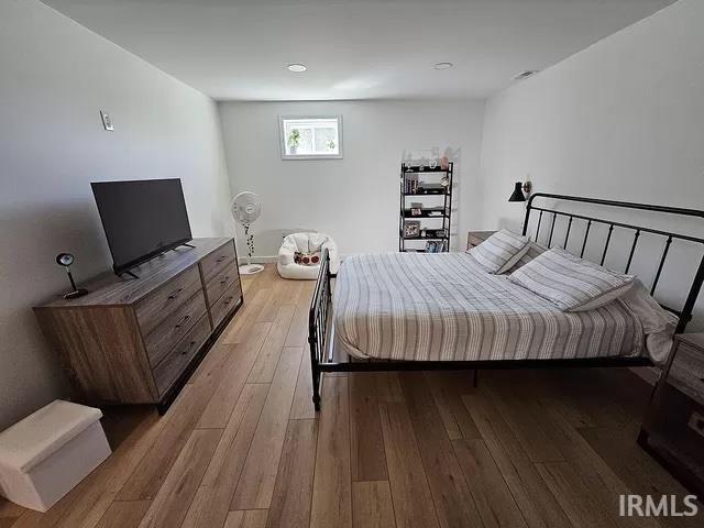 bedroom with light hardwood / wood-style floors