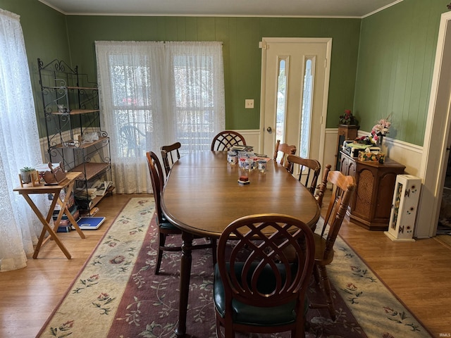 dining space featuring ornamental molding and light hardwood / wood-style floors