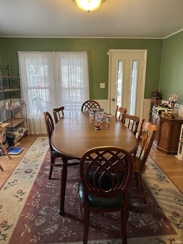 dining room featuring ornamental molding, hardwood / wood-style floors, and a wealth of natural light