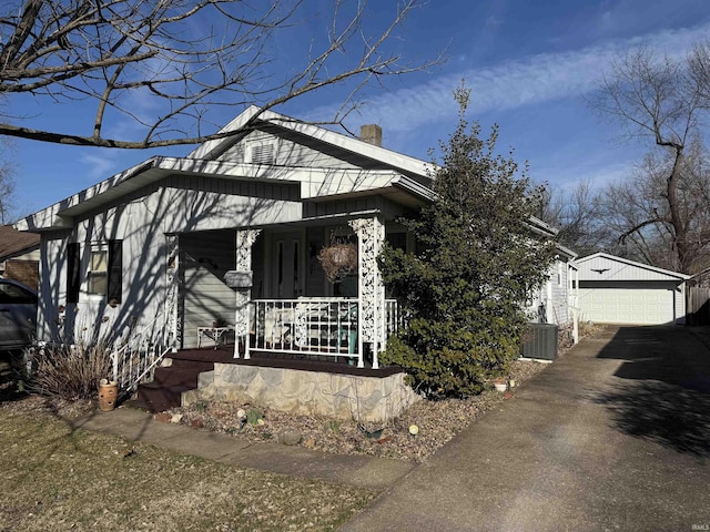 bungalow-style home with a garage, an outdoor structure, and covered porch