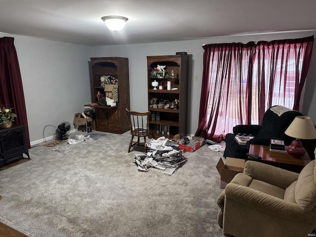 living room with carpet floors and a wood stove