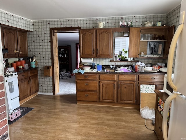 kitchen featuring white appliances and light wood-type flooring