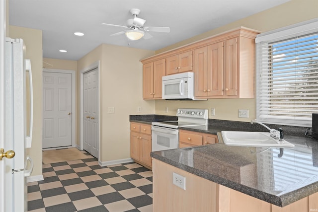 kitchen featuring sink, white appliances, ceiling fan, light brown cabinetry, and kitchen peninsula