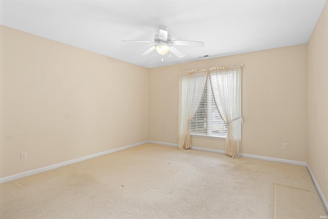 empty room featuring light carpet and ceiling fan