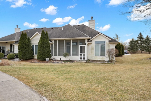 view of front of property with a front lawn and a sunroom