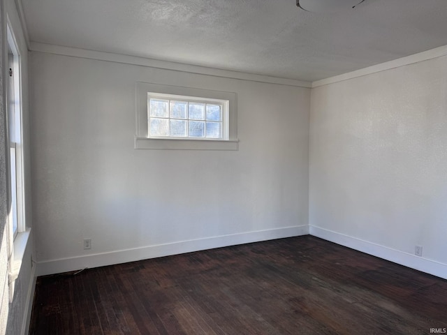 605 W 10th St, Muncie, IN 47302 - spare room with dark hardwood / wood-style floors and a textured ceiling