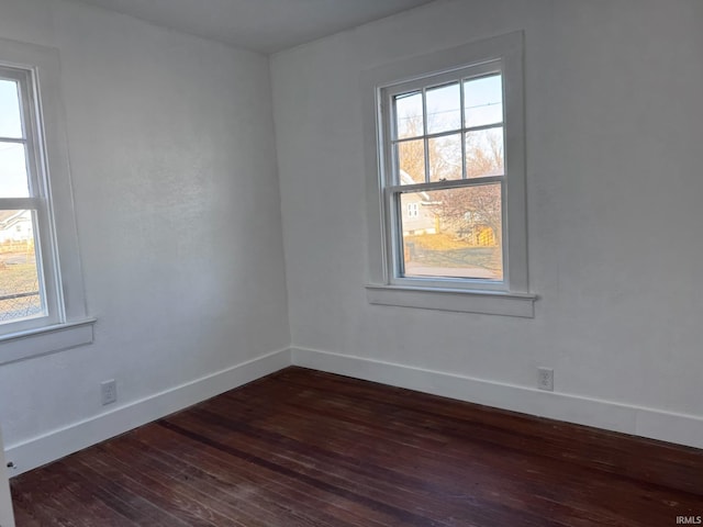 605 W 10th St, Muncie, IN 47302 - spare room with plenty of natural light and dark hardwood / wood-style floors
