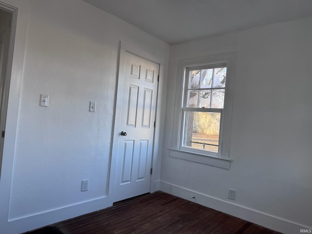 605 W 10th St, Muncie, IN 47302 - spare room featuring dark wood-type flooring