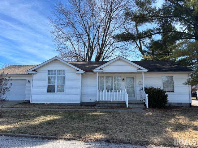 single story home with a garage, a front yard, and covered porch