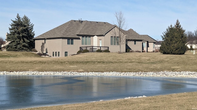 rear view of property with a lawn