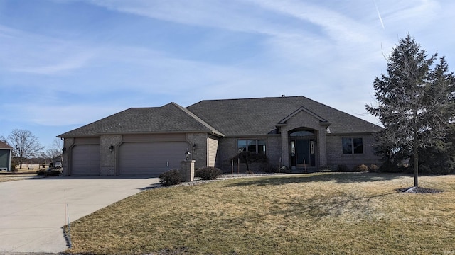 view of front of house with a garage and a front lawn