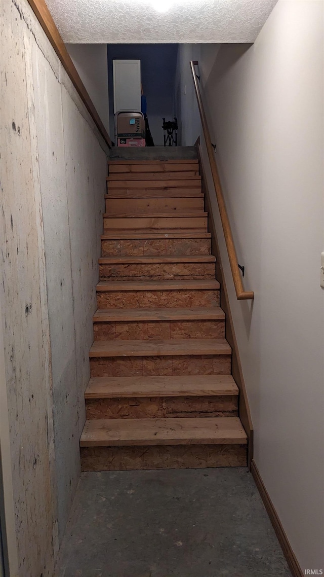 stairway with concrete floors