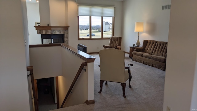 living room with light carpet and a fireplace