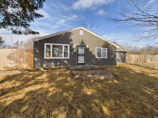 view of front of house with a patio and a front lawn