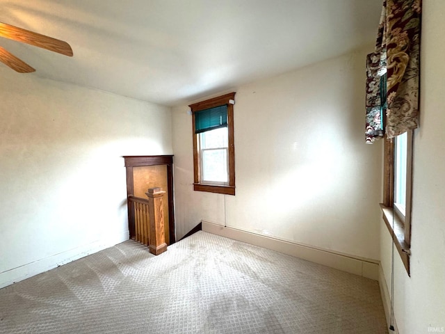 carpeted empty room featuring ceiling fan