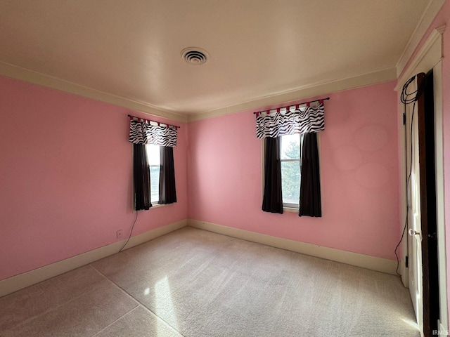 empty room with ornamental molding and plenty of natural light