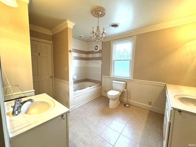 bathroom featuring vanity, a bathtub, ornamental molding, and toilet