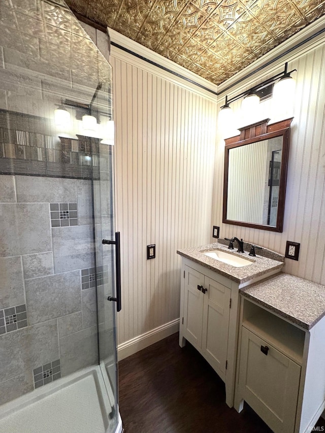 bathroom featuring vanity, an enclosed shower, and wood-type flooring