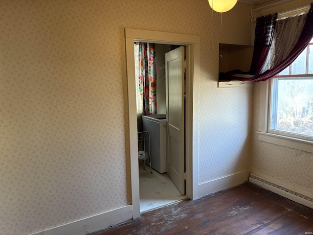 interior space with washer / dryer, dark hardwood / wood-style floors, and baseboard heating