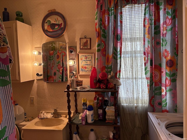 bathroom featuring washer / dryer and sink