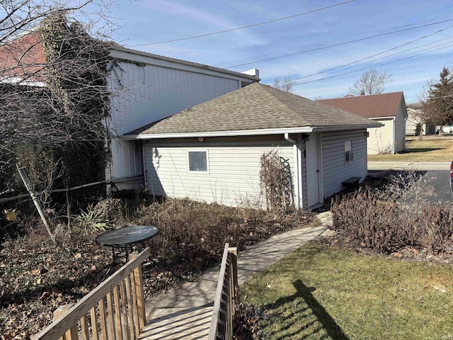 view of side of property with a lawn