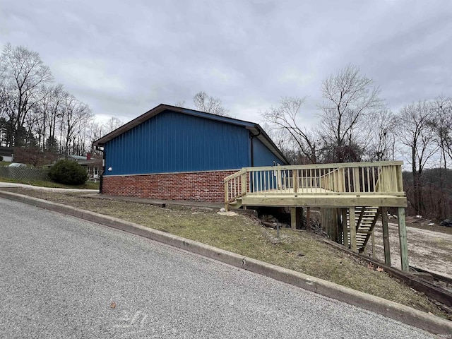 view of side of home with a wooden deck