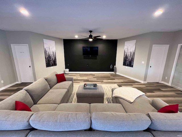 home theater featuring hardwood / wood-style flooring and ceiling fan