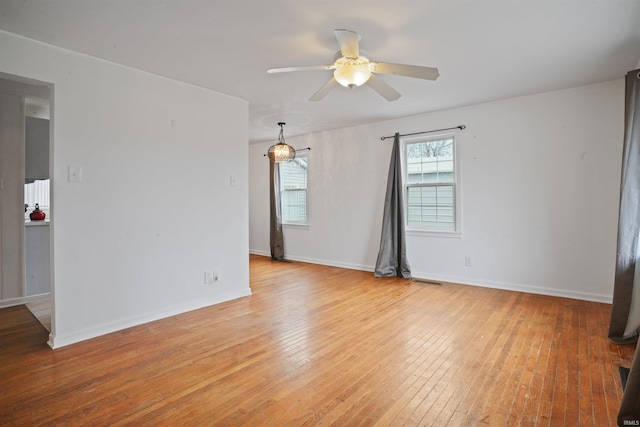 empty room with ceiling fan and light wood-type flooring