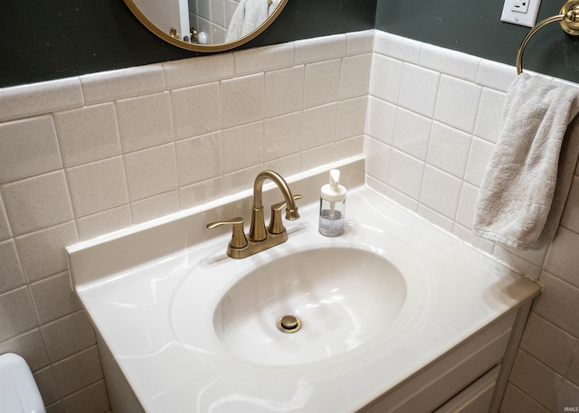 bathroom with sink and tile walls