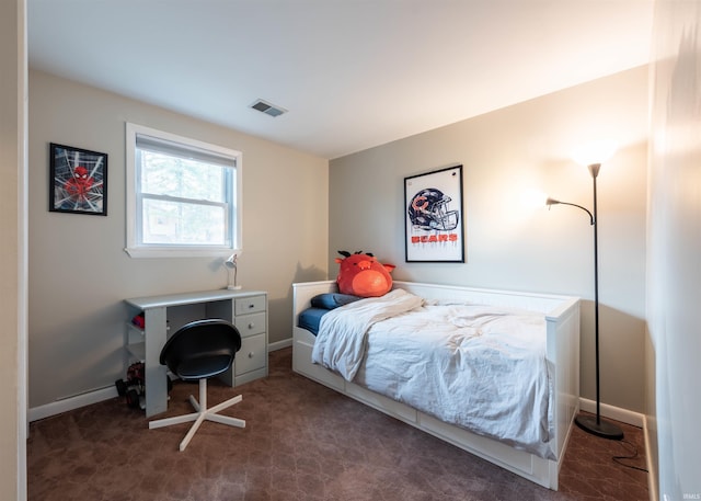 bedroom with dark colored carpet