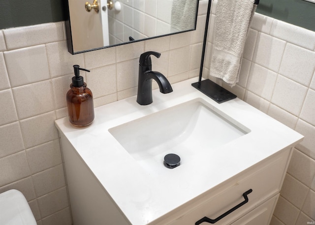 bathroom featuring tasteful backsplash, vanity, and tile walls