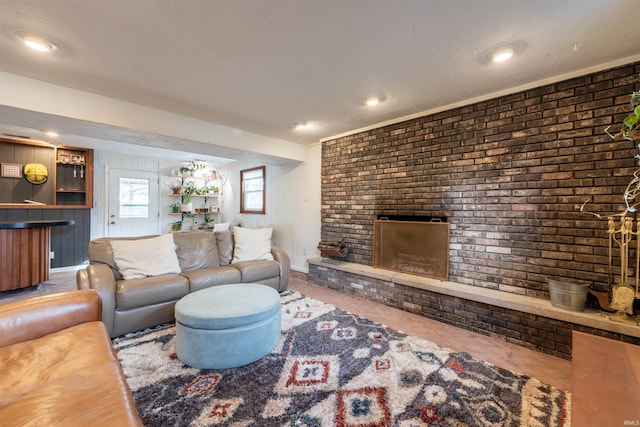 living room featuring brick wall and a brick fireplace