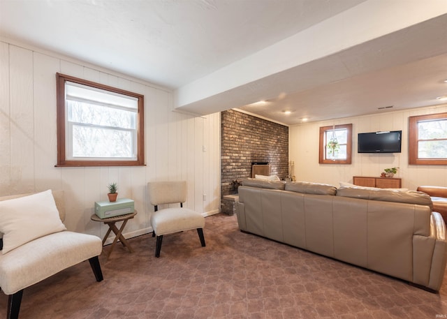 living room featuring carpet and a fireplace