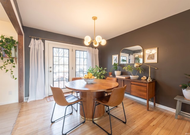 dining room featuring a notable chandelier and light hardwood / wood-style floors