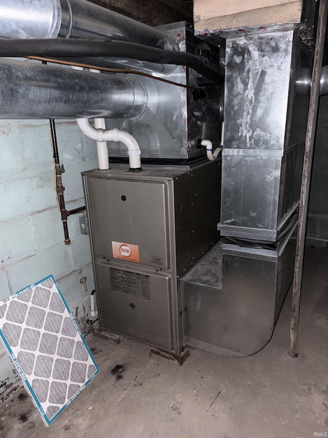 utility room featuring heating unit