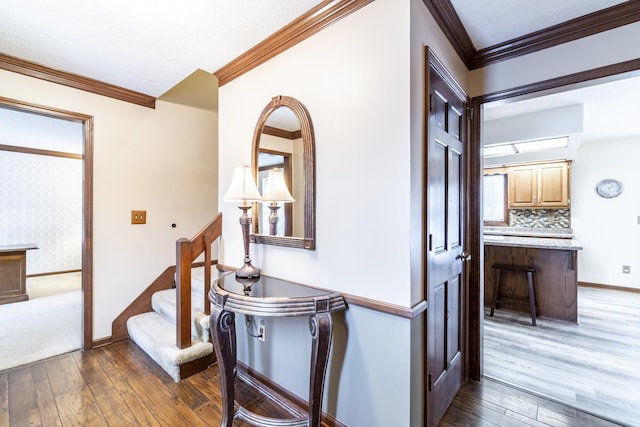 hall featuring ornamental molding and dark hardwood / wood-style flooring