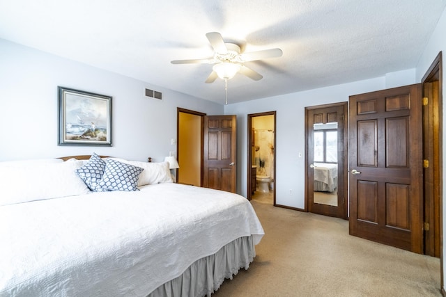 carpeted bedroom featuring a textured ceiling, ceiling fan, and ensuite bathroom