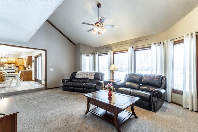 carpeted living room with vaulted ceiling, ceiling fan, and plenty of natural light