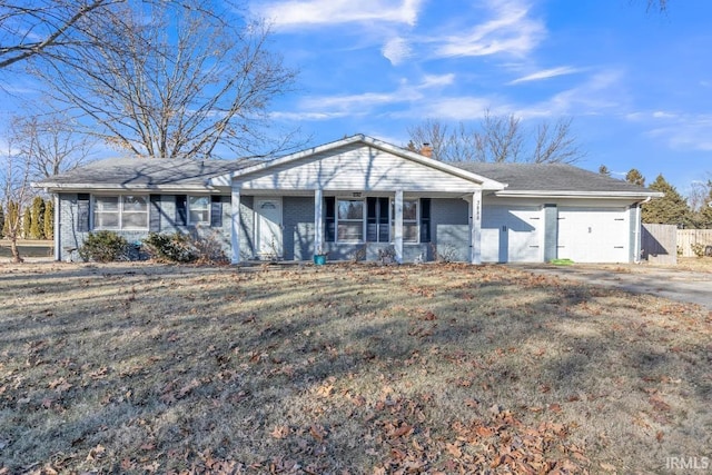 ranch-style home with a garage and a front yard