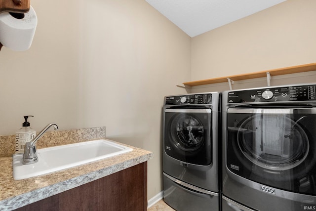 clothes washing area featuring separate washer and dryer and sink