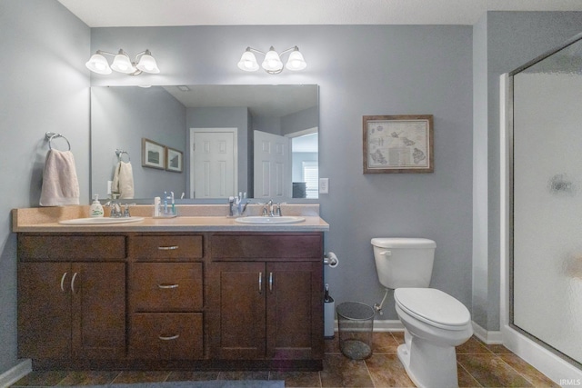 bathroom with vanity, tile patterned flooring, toilet, and walk in shower