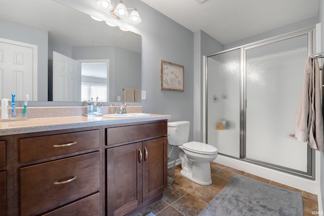 bathroom featuring vanity, toilet, and a shower with door