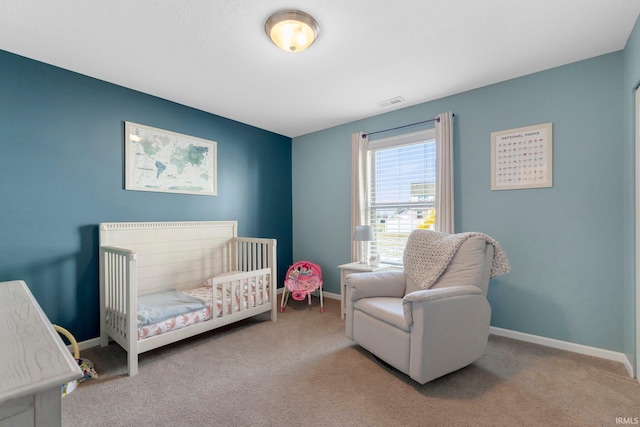 carpeted bedroom featuring a crib