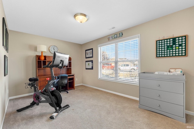 workout room featuring light colored carpet