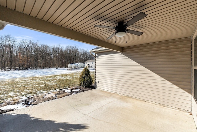 snow covered patio featuring ceiling fan