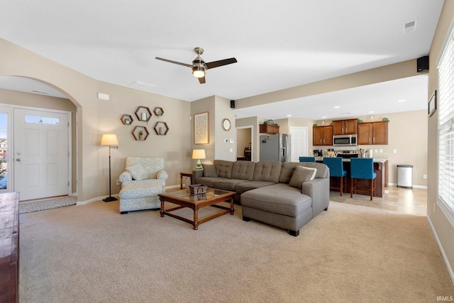 carpeted living room with ceiling fan