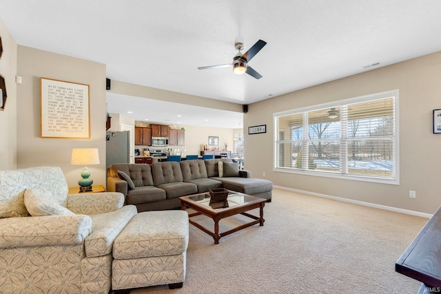 living room featuring light carpet and ceiling fan