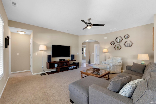 living room with light carpet, a healthy amount of sunlight, and ceiling fan