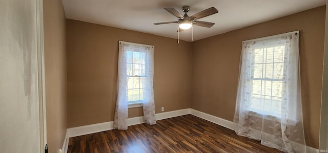 unfurnished room with ceiling fan and dark hardwood / wood-style flooring