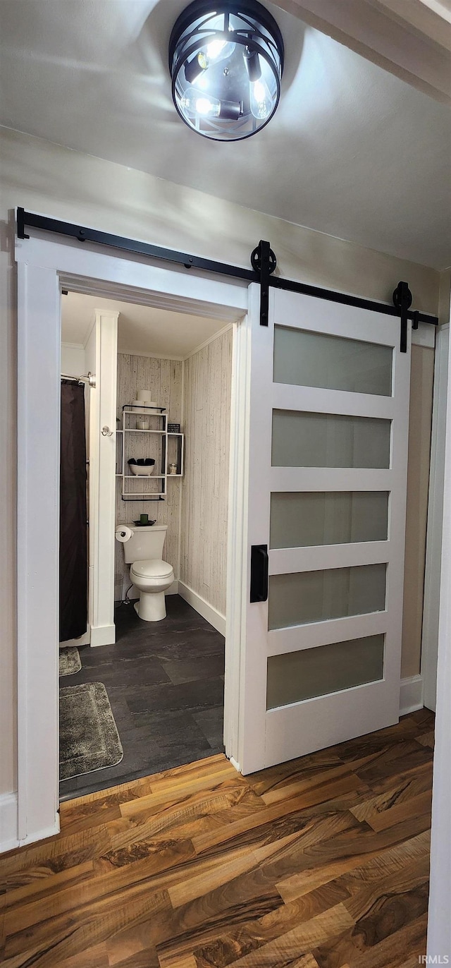 bathroom featuring wood-type flooring and toilet